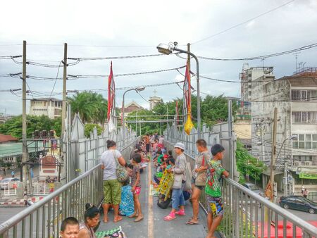 Bangkok, Thailand - August 7, 2014 : Many people are waiting for donations on the overcrossing.のeditorial素材