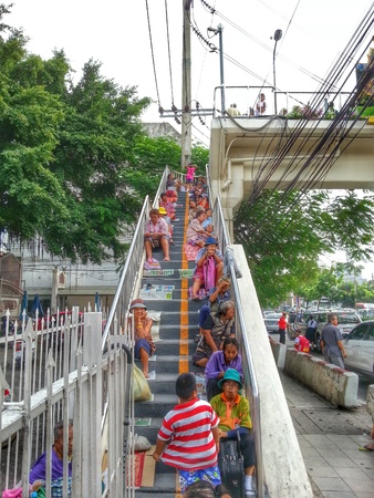 Bangkok, Thailand - August 7, 2014 : Many people are waiting for donations on the overcrossing.のeditorial素材
