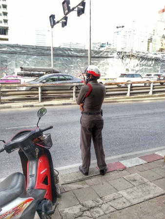 Bangkok, Thailand - July 23, 2014 : Traffic police is directing traffic on the road in Bangkok during rush hour.のeditorial素材