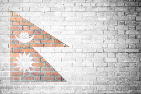 Brick wall texture background with flag of Nepalの写真素材