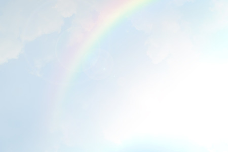 Blue sky and white cloud with sun light and rainbowの写真素材