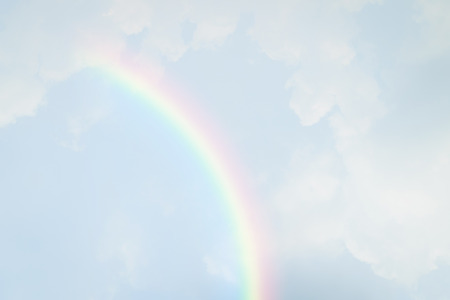 Blue sky and white cloud with sun light and rainbowの写真素材