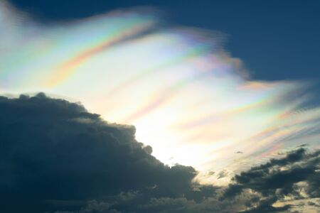 Rare fire rainbow in dark stormy clouds circumhorizontal arc. No effect and not lens flares.の写真素材