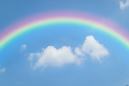 Nature cloudscape with blue sky and white cloud with rainbowの写真素材