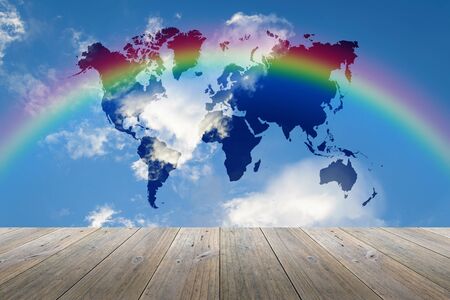 Wood terrace and Blue sky background with world map and rainbowの写真素材
