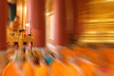 Blurred zoom of  Thai monk worship in temple at Wat Thep Sirin Thrawat Ratchaworawihan.の写真素材