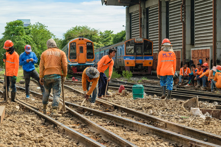 Bangkok, Thailand - September 13, 2015 : Unidentified railway employees working for restoration the railroad tracks before serving at State Railway of Thailand.のeditorial素材