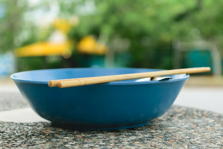 Bowl and chopsticks on a tableの写真素材