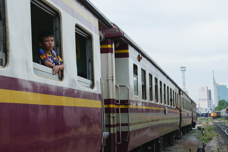 Bangkok, Thailand - September 5, 2015 : Unidentified boy on the train. Many people in Thailand popular travel by train because it is cheaper.のeditorial素材