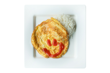 Omelet rice in white dish with smiling chilli sauce. isolated on white background.の写真素材