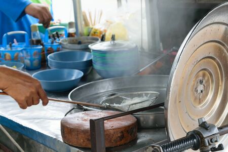 Cooking chinese egg noodles with red porkの写真素材
