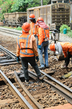 Bangkok, Thailand - September 5, 2015 : Unidentified railway employees working for restoration the railroad tracks before serving at State Railway of Thailand.のeditorial素材