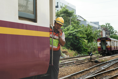 Bangkok, Thailand - September 5, 2015 : Unidentified railway employees controlling the locomotive for switching the railway before serving at State Railway of Thailand.のeditorial素材