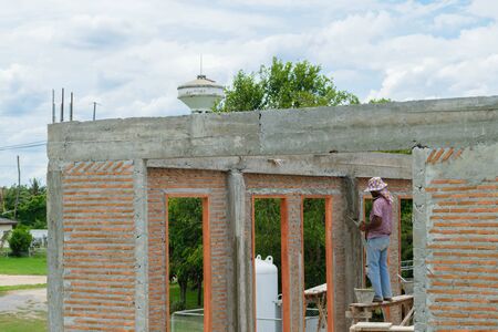 Bangkok, Thailand - May 22, 2015 : Unidentified construction worker mixing cement for building.のeditorial素材