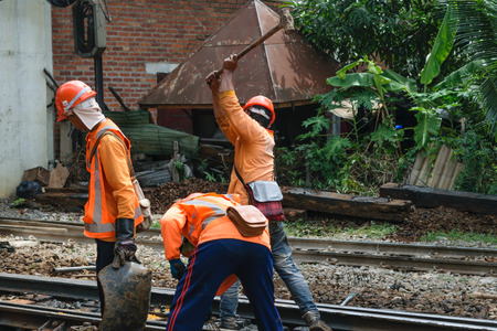 Bangkok, Thailand - September 5, 2015 : Unidentified railway employees working for restoration the railroad tracks before serving at State Railway of Thailand.のeditorial素材