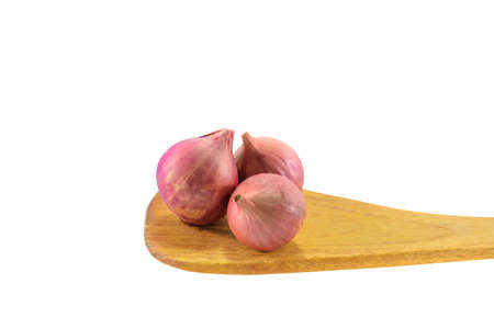 Shallot or Onions on wooden spoon isolated on white background, Clipping path included.の写真素材