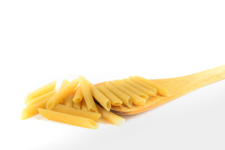 Macaroni on wooden spoon isolated on white backgroundの写真素材