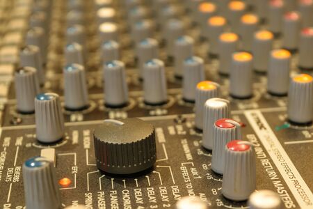 Sound mixer control. Selective focus on volume buttons.
