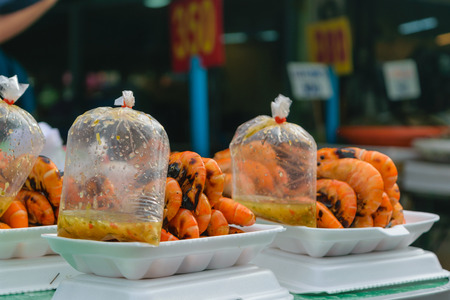 Grilled shrimp in foam box at Thai marketの写真素材