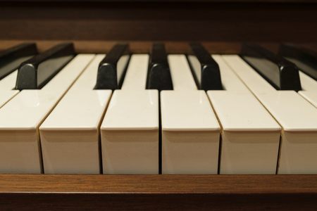Piano keys on wooden musical instrumentの写真素材