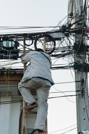 Bangkok, Thailand - November 16, 2015 : Unidentified worker working to install internet fiber system in village at Bangkok Thailand.のeditorial素材