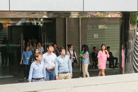 Bangkok, Thailand - November 20, 2015 : Many working people preparedness for fire drill or other disaster at office in Bangkok Thailandのeditorial素材