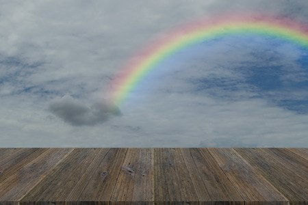 Wood terrace and Blue sky and white cloud with rainbowの写真素材