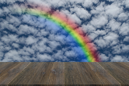 Wood terrace and Blue sky and white cloud with rainbowの写真素材