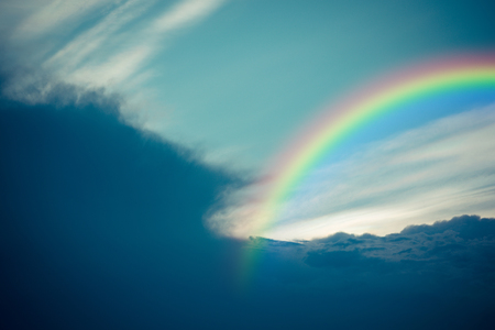 Nature cloudscape with blue sky and white cloud with rainbow , process in vintage styleの写真素材