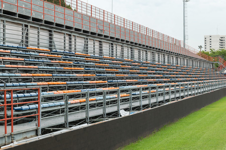 Football stadium with row of seats blue and orange color. This is a public place Does not require a...
