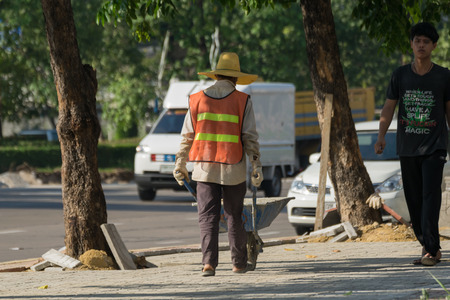 Bangkok, Thailand - November 21, 2015 : Unidentified worker laying paver bricks paver making sidewalkのeditorial素材