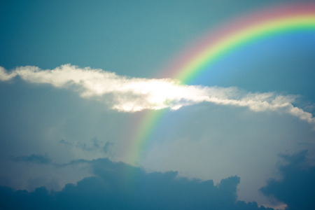 Nature cloudscape with blue sky and white cloud with rainbow , process in vintage styleの写真素材
