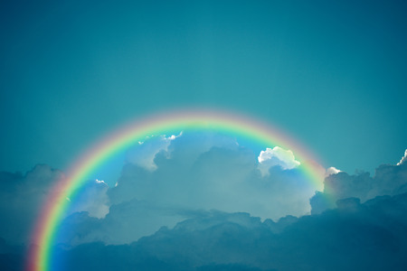 Nature cloudscape with blue sky and white cloud with rainbow , process in vintage styleの写真素材