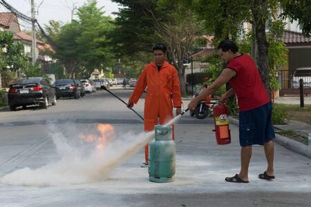 Bangkok, Thailand - January 31, 2016 : Many people preparedness for fire drill and training to use a fire safety tank in village at Bangkok Thailand.のeditorial素材