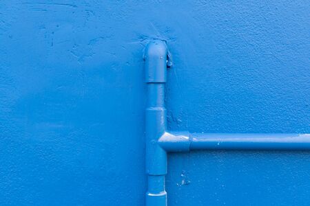 Minimalism style, Blue water pipe on blue wall texture background.の写真素材
