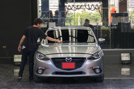 Bangkok, Thailand - December 12, 2015 : Unidentified car care staff cleaning the car.のeditorial素材