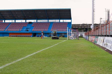 Bangkok, Thailand - January 25, 2016 : Unidentified man mowing the grass on a football stadium at PAT Stadium. PAT Stadium is a stadium in the Khlong Toei district Bangkok, Thailand.のeditorial素材