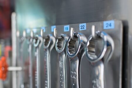 Collection of spanners wrench tools tidy on board in garage