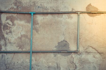 Minimalism style, Dirty green water pipe on the old wall texture background. , process in vintage...
