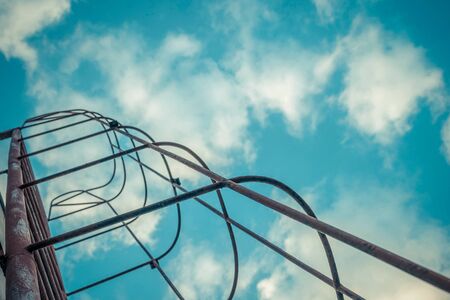 Silhouette of fixed ladder upto the blue sky with cloud , process in vintage styleの写真素材