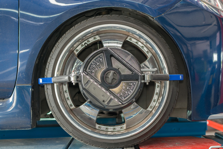 Checking suspension in a car by tool electronic tools at  car garageの写真素材