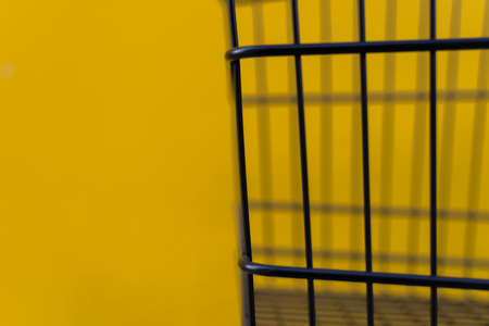 Minimalism style, Shopping cart black color and yellow wall at supermarket.の写真素材