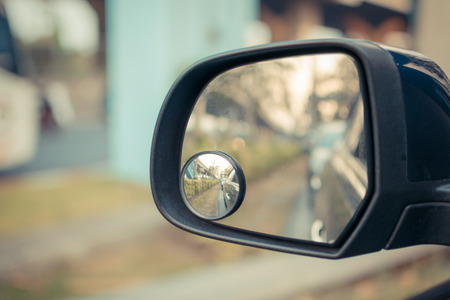 Car side mirror for rear view with traffic reflection background , process in vintage styleの写真素材