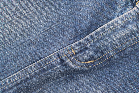 Detail of blue jeans crotch with yellow stitch
