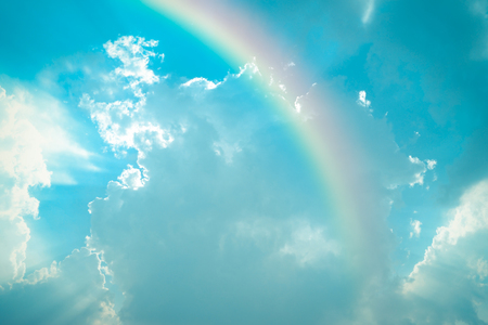 Nature cloudscape with blue sky and white cloud with rainbow , process in vintage styleの写真素材