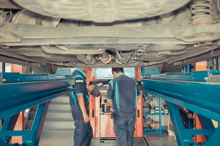 Checking suspension in a car by tool electronic tools at  car garage , process in vintage styleのeditorial素材