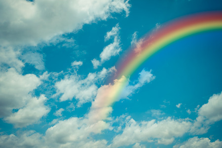 Nature cloudscape with blue sky and white cloud with rainbow , process in vintage styleの写真素材