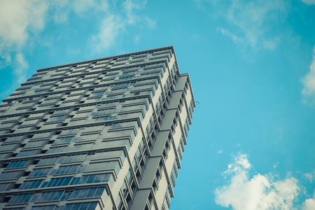 Big glass building with blue sky and white cloud