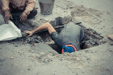 Working for drain cleaning. Problem with the drainage system.の写真素材