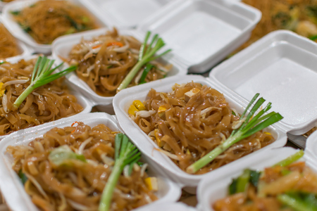 Thai street food with fried noodle in market.の写真素材